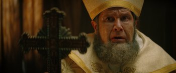 Movie still from “Renfield” (2023), directed by Chris McKay – A person with a cross; Close Up shot, Low angle