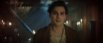 Movie still from “Renfield” (2023), directed by Chris McKay – A person wearing a suit and tie; Close Up shot, Low angle