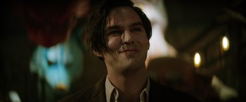 Movie still from “Renfield” (2023), directed by Chris McKay – A person wearing a suit and tie; Close Up shot, Low angle