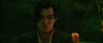 Movie still from “Renfield” (2023), directed by Chris McKay – A person wearing a suit and tie; Close Up shot, Over the shoulder angle