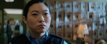 Movie still from “Renfield” (2023), directed by Chris McKay – A man in a police uniform looking to his left; Close Up shot, Over the shoulder angle