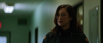 Movie still from “Renfield” (2023), directed by Chris McKay – A woman in a uniform looking to her left; Close Up shot, Low angle