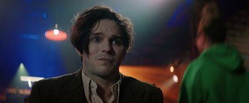 Movie still from “Renfield” (2023), directed by Chris McKay – A person wearing a suit and tie; Close Up shot, Low angle