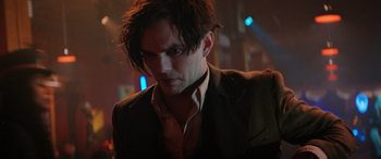 Movie still from “Renfield” (2023), directed by Chris McKay – A person wearing a suit and tie; Close Up shot, Low angle
