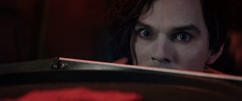 Movie still from “Renfield” (2023), directed by Chris McKay – A person's face looking at the camera; Extreme Close Up shot, Overhead angle