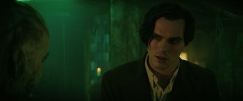 Movie still from “Renfield” (2023), directed by Chris McKay – A man with long hair and a jacket on; Close Up shot, Over the shoulder angle