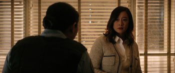 Movie still from “Renfield” (2023), directed by Chris McKay – A woman and a boy are standing in front of a window; Medium shot, Over the shoulder angle