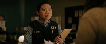 Movie still from “Renfield” (2023), directed by Chris McKay – A woman holding a piece of paper in her hands; Close Up shot, Over the shoulder angle