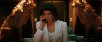 Movie still from “Renfield” (2023), directed by Chris McKay – A woman talking on a cell phone while wearing a white suit; Medium shot, Low angle