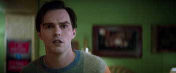 Movie still from “Renfield” (2023), directed by Chris McKay – A person wearing a sweater and looking at the camera; Close Up shot, Low angle