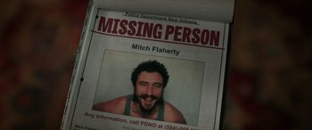 Movie still from “Renfield” (2023), directed by Chris McKay – A missing person poster of a man with a beard; Extreme Close Up shot, Overhead angle