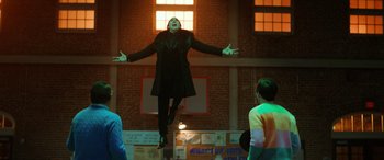 Movie still from “Renfield” (2023), directed by Chris McKay – A woman in a black dress is flying through the air; Wide shot, Low angle