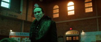 Movie still from “Renfield” (2023), directed by Chris McKay – A man in a black jacket and a fur collar; Medium shot, Low angle