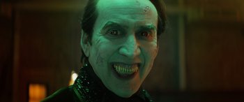 Movie still from “Renfield” (2023), directed by Chris McKay – A person wearing a green costume; Close Up shot, High angle