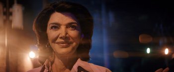 Movie still from “Renfield” (2023), directed by Chris McKay – A woman's face in front of a blue background; Close Up shot, Low angle