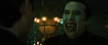 Movie still from “Renfield” (2023), directed by Chris McKay – A man with a vampire make - up on his face; Close Up shot, Over the shoulder angle