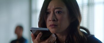 Movie still from “Renfield” (2023), directed by Chris McKay – A person holding a cell phone; Close Up shot, Low angle