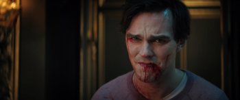 Movie still from “Renfield” (2023), directed by Chris McKay – A man with blood on his face and mouth; Close Up shot, Over the shoulder angle