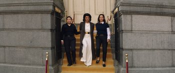 Movie still from “Renfield” (2023), directed by Chris McKay – A group of women walking down a set of stairs; Wide shot, Low angle