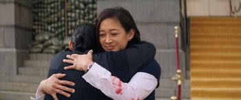 Movie still from “Renfield” (2023), directed by Chris McKay – A woman is hugging another woman outside; Medium shot, Over the shoulder angle