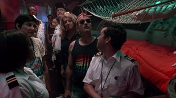 Movie still from “Reno 911!: The Hunt for QAnon” (2021), directed by Robert Ben Garant – A group of people standing next to each other on a boat; Medium shot, Low angle