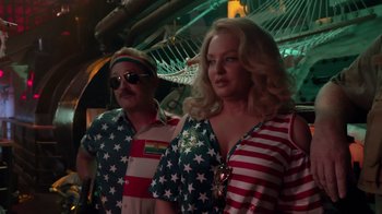 Movie still from “Reno 911!: The Hunt for QAnon” (2021), directed by Robert Ben Garant – A man and a woman dressed in patriotic clothing; Medium shot, Low angle