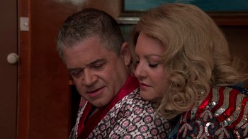 Movie still from “Reno 911!: The Hunt for QAnon” (2021), directed by Robert Ben Garant – A man and a woman are hugging each other; Close Up shot, Over the shoulder angle