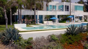 Movie still from “Reno 911!: The Hunt for QAnon” (2021), directed by Robert Ben Garant – A group of people standing next to a swimming pool; Extreme Wide shot, High angle