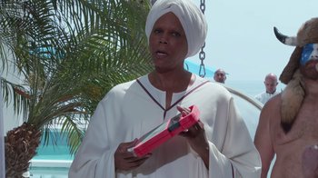 Movie still from “Reno 911!: The Hunt for QAnon” (2021), directed by Robert Ben Garant – A woman in a white robe holding a pair of pink scissors; Close Up shot, Low angle