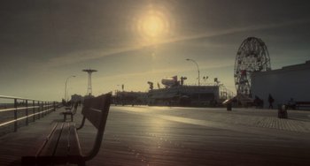 Movie still from “Requiem for a Dream” (2000), directed by Darren Aronofsky – A view of a boardwalk with a ferris wheel and ferris wheel; Extreme Wide shot, Low angle