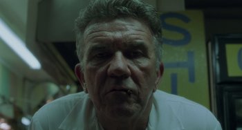 Movie still from “Requiem for a Dream” (2000), directed by Darren Aronofsky – An older man with a cigarette in his mouth; Close Up shot, Low angle