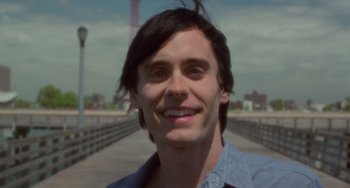 Movie still from “Requiem for a Dream” (2000), directed by Darren Aronofsky – A person with long black hair; Close Up shot, Over the shoulder angle