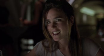 Movie still from “Requiem for a Dream” (2000), directed by Darren Aronofsky – A beautiful young lady smiling for the camera; Close Up shot, Over the shoulder angle