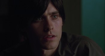 Movie still from “Requiem for a Dream” (2000), directed by Darren Aronofsky – A man's face in a dark room; Close Up shot, High angle