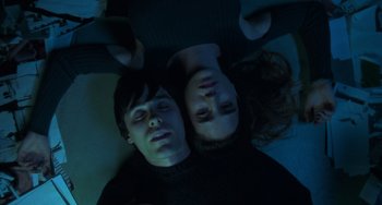 Movie still from “Requiem for a Dream” (2000), directed by Darren Aronofsky – A man and a woman laying on the ground; Medium shot, Overhead angle