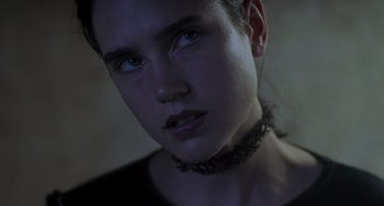 Movie still from “Requiem for a Dream” (2000), directed by Darren Aronofsky – A person wearing a necklace; Close Up shot, Over the shoulder angle