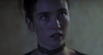 Movie still from “Requiem for a Dream” (2000), directed by Darren Aronofsky – A person wearing a necklace; Close Up shot, Over the shoulder angle