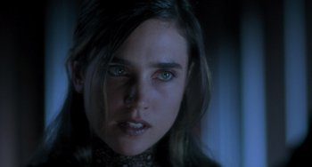 Movie still from “Requiem for a Dream” (2000), directed by Darren Aronofsky – A person with long hair and green eyes; Close Up shot, Over the shoulder angle