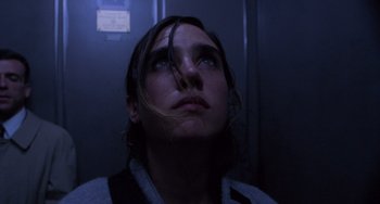 Movie still from “Requiem for a Dream” (2000), directed by Darren Aronofsky – A man with long hair looking up into the dark; Close Up shot, Low angle