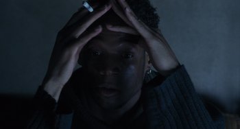 Movie still from “Requiem for a Dream” (2000), directed by Darren Aronofsky – A man holding his head with a cigarette in his hand; Close Up shot, Overhead angle