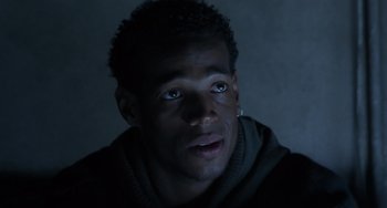 Movie still from “Requiem for a Dream” (2000), directed by Darren Aronofsky – A young man with blue eyes stares into the camera; Close Up shot, Over the shoulder angle