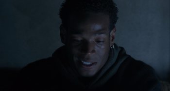 Movie still from “Requiem for a Dream” (2000), directed by Darren Aronofsky – A young man with his eyes closed in the dark; Close Up shot, Over the shoulder angle