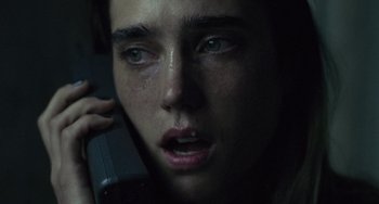 Movie still from “Requiem for a Dream” (2000), directed by Darren Aronofsky – A person talking on a cell phone; Extreme Close Up shot, High angle