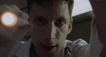 Movie still from “Requiem for a Dream” (2000), directed by Darren Aronofsky – A person with a stethoscope; Close Up shot, Low angle