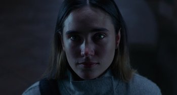 Movie still from “Requiem for a Dream” (2000), directed by Darren Aronofsky – A person wearing a gray shirt; Close Up shot, Low angle