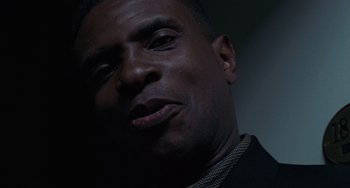 Movie still from “Requiem for a Dream” (2000), directed by Darren Aronofsky – A man's face in the dark; Close Up shot, Low angle