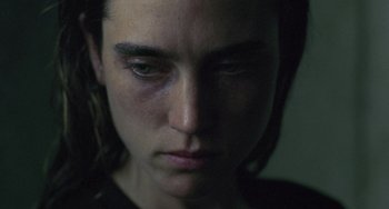 Movie still from “Requiem for a Dream” (2000), directed by Darren Aronofsky – A person's face in a dark room; Extreme Close Up shot, High angle