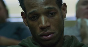 Movie still from “Requiem for a Dream” (2000), directed by Darren Aronofsky – A person with a piercing on his ear; Close Up shot, Low angle