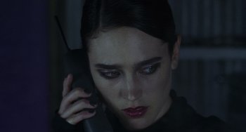 Movie still from “Requiem for a Dream” (2000), directed by Darren Aronofsky – A person talking on a cell phone; Close Up shot, High angle