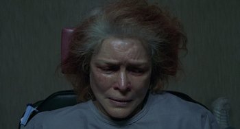 Movie still from “Requiem for a Dream” (2000), directed by Darren Aronofsky – An older woman is crying in the dark; Close Up shot, Overhead angle
